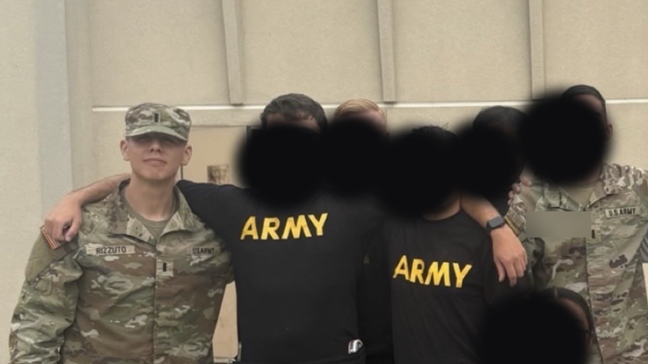 Anthony Rizzuto Jr. in Army uniform posing with fellow soldiers
