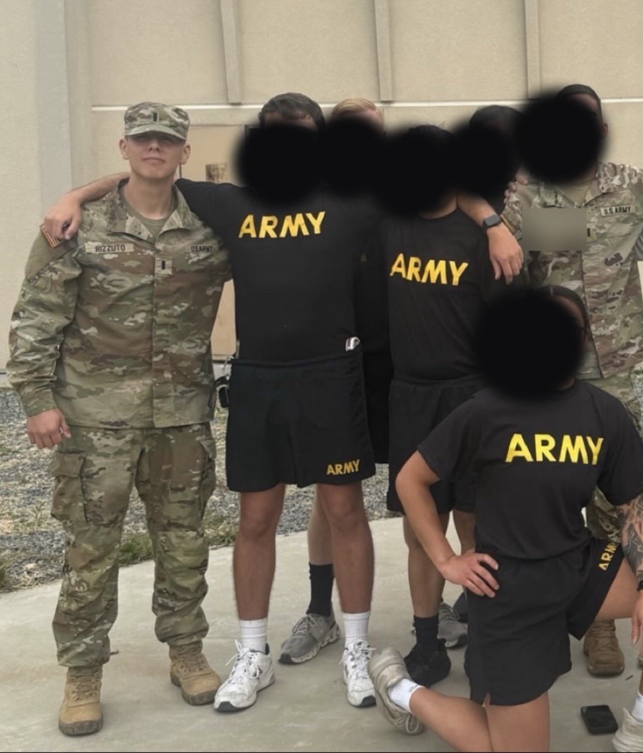 Anthony Rizzuto Jr. in Army uniform posing with fellow soldiers